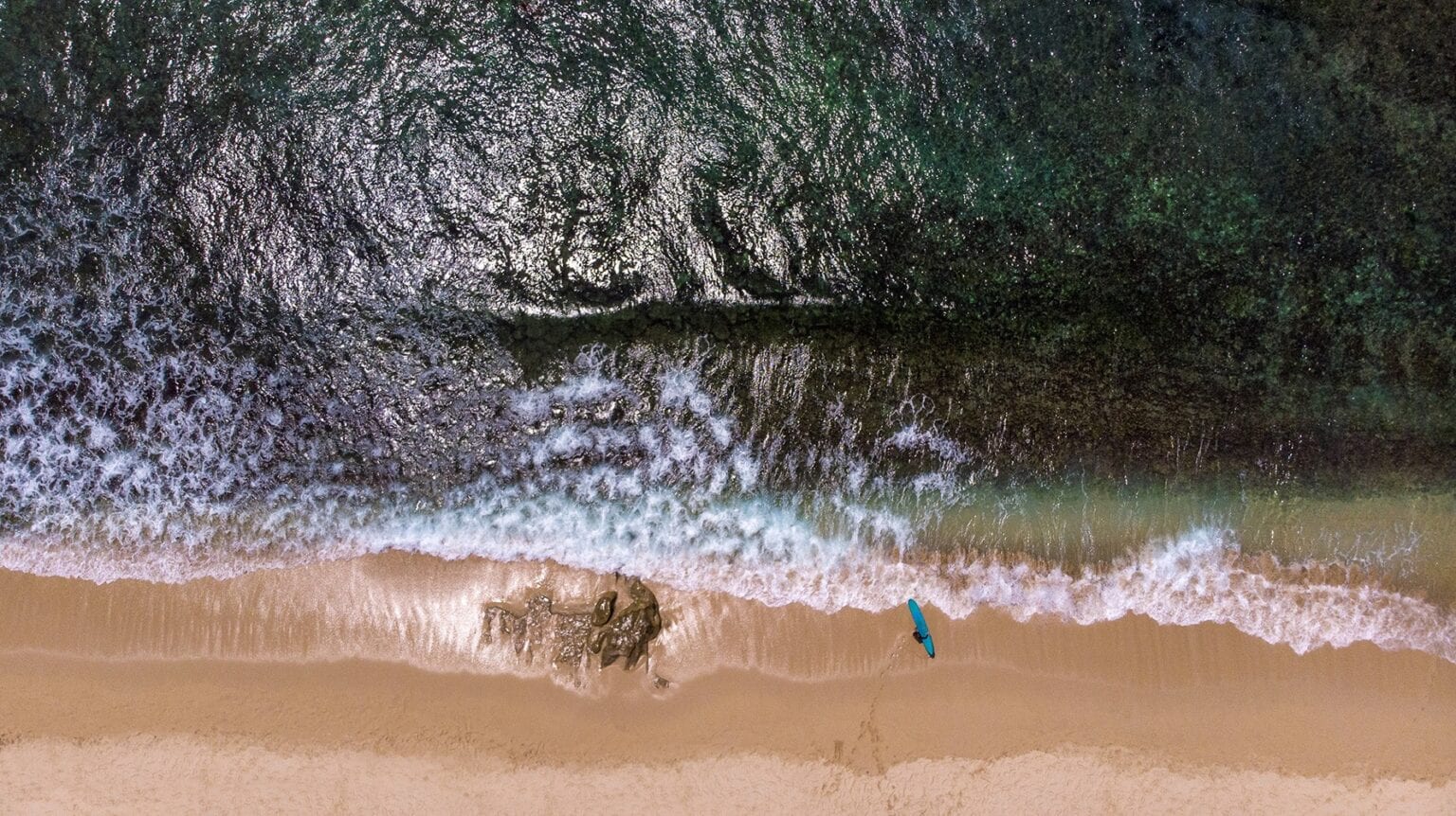 drone aerial photography at beach surfer, Bali, Indonesia